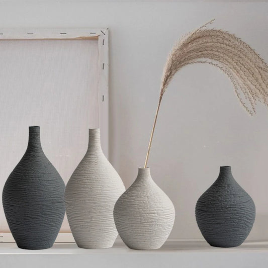 Beige and grey ribbed ceramic bud vases on a shelf