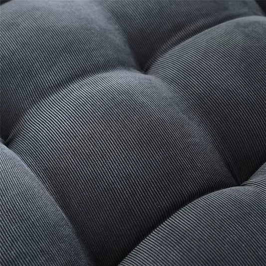 Close view of the tufted dark grey corduroy surface.