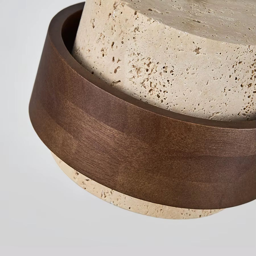 Close view of the dark wood band around the travertine shade