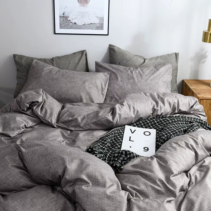 Close view of the grey duvet cover and pillowcases on a bed.