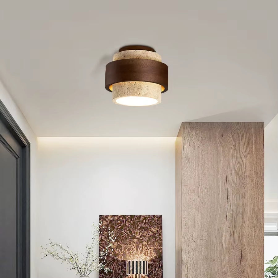Stepped travertine ceiling light lit on a hallway ceiling
