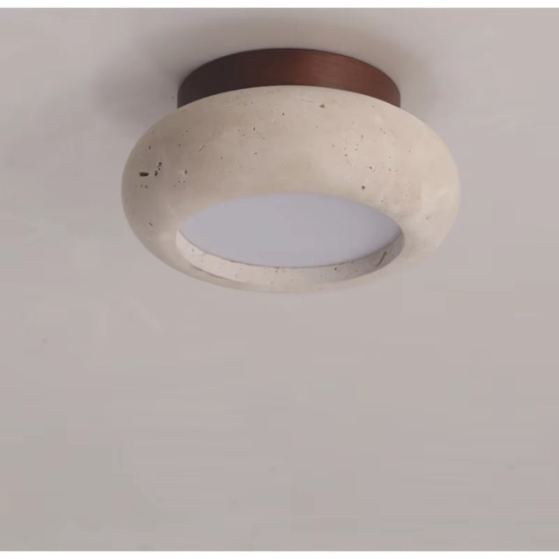Rounded travertine flush mount ceiling light with the dark wood canopy, close view