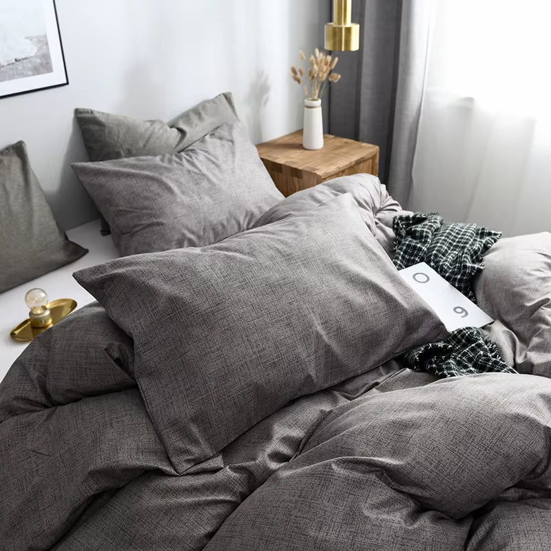 Grey pillowcase resting on the matching duvet cover.