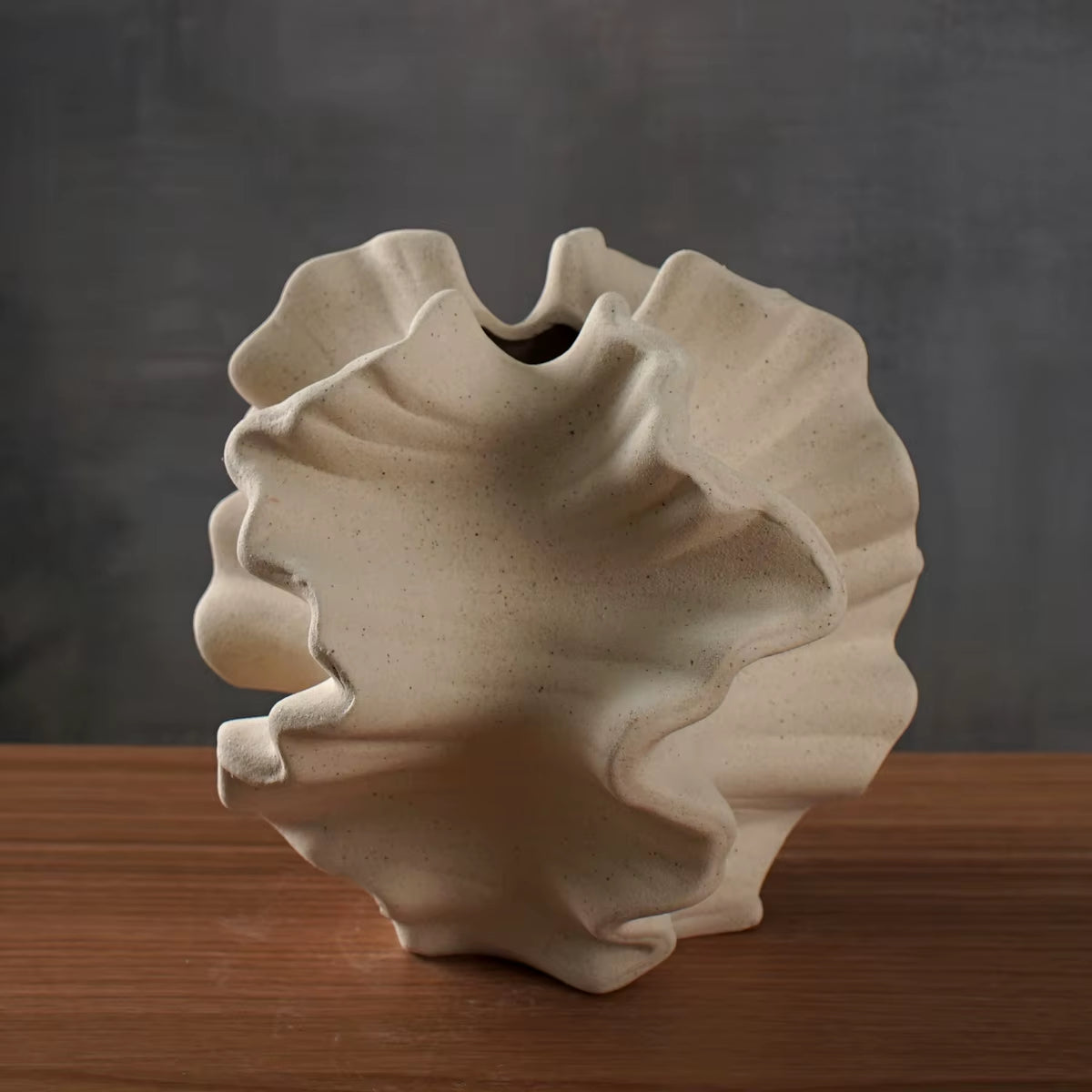 Beige coral texture ceramic vase on a wood table