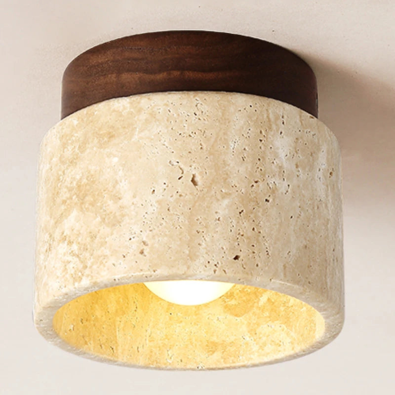 Round stone ceiling light with a walnut-color wood top, lit, seen from below.