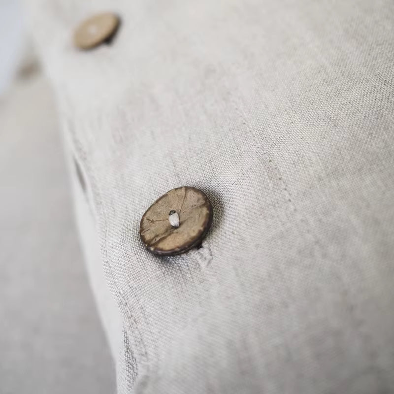 Close view of linen weave and a button closure.