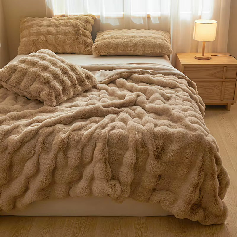 Faux rabbit fur throw draped on a bed or sofa