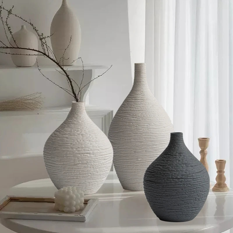 Ribbed ceramic bud vases on a round table