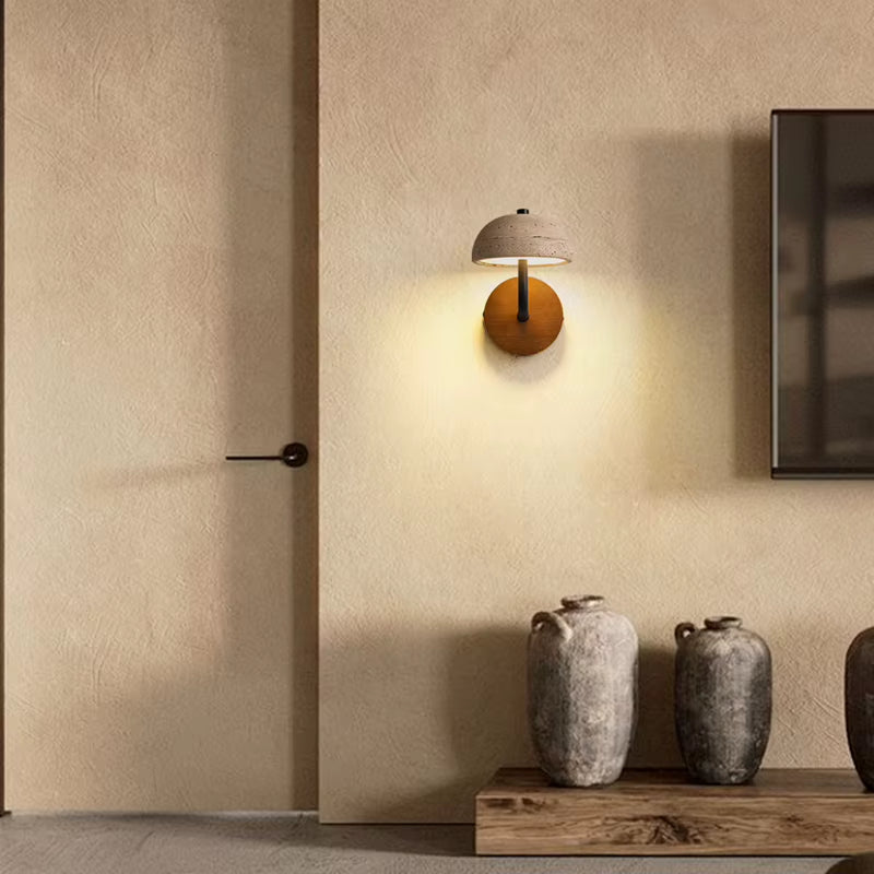 Travertine dome wall sconce on a hallway wall beside a door