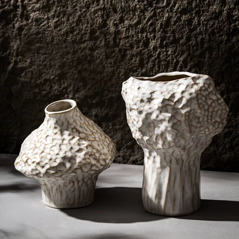 Short and tall hammered ceramic vases in matte white, shown empty.