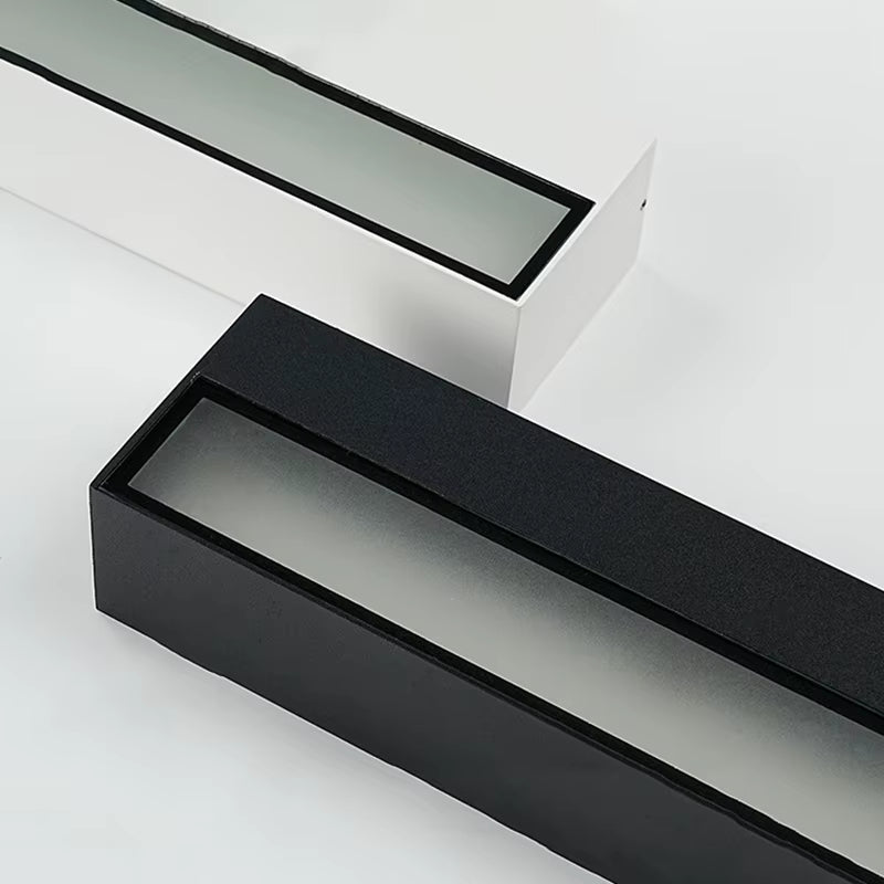 Black and white aluminum wall light bodies, close view