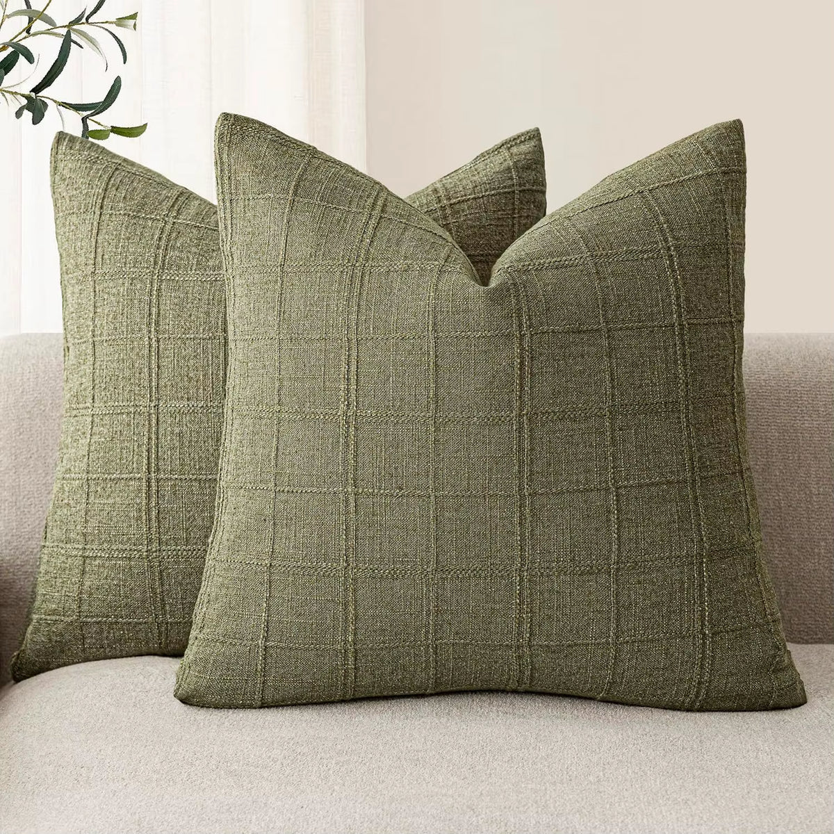 Sage chenille throw pillow covers on a sofa