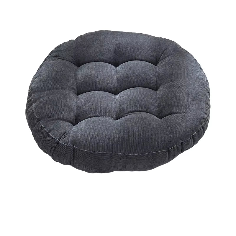 Round dark grey tufted corduroy seat cushion on a white background.