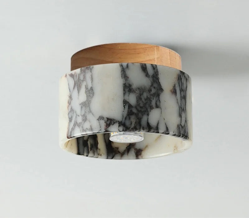 Marble flush mount ceiling light with a light wood canopy, unlit, seen from below