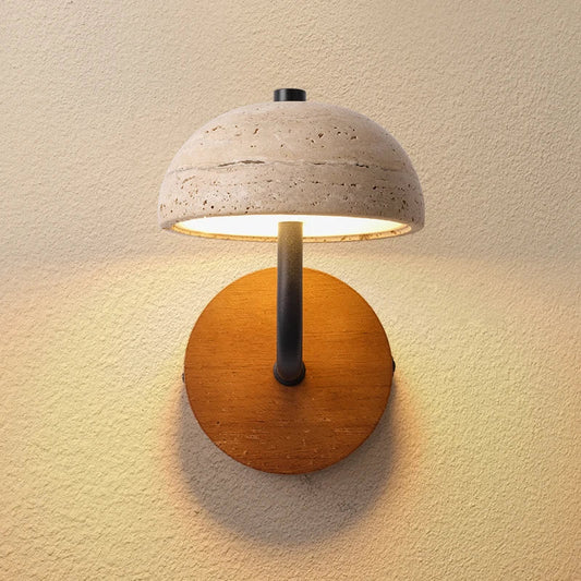 Travertine dome wall sconce on a round wood backplate, lit, front view