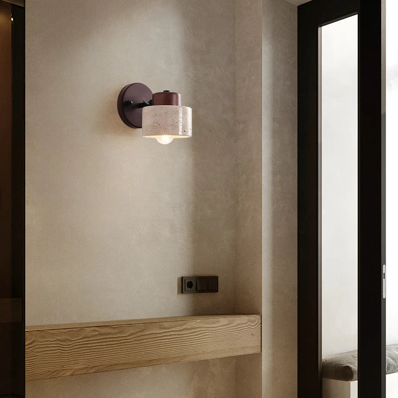 Travertine drum wall sconce on a hallway wall