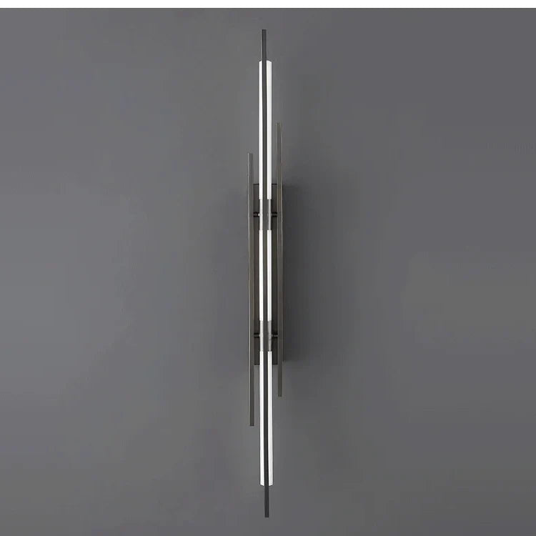 Linear black wall sconce unlit on a plain gray wall, front view