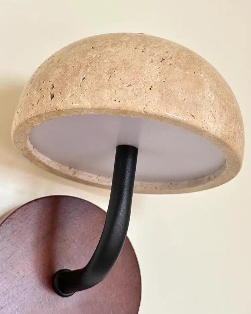 Close view of the travertine dome shade and black arm from below