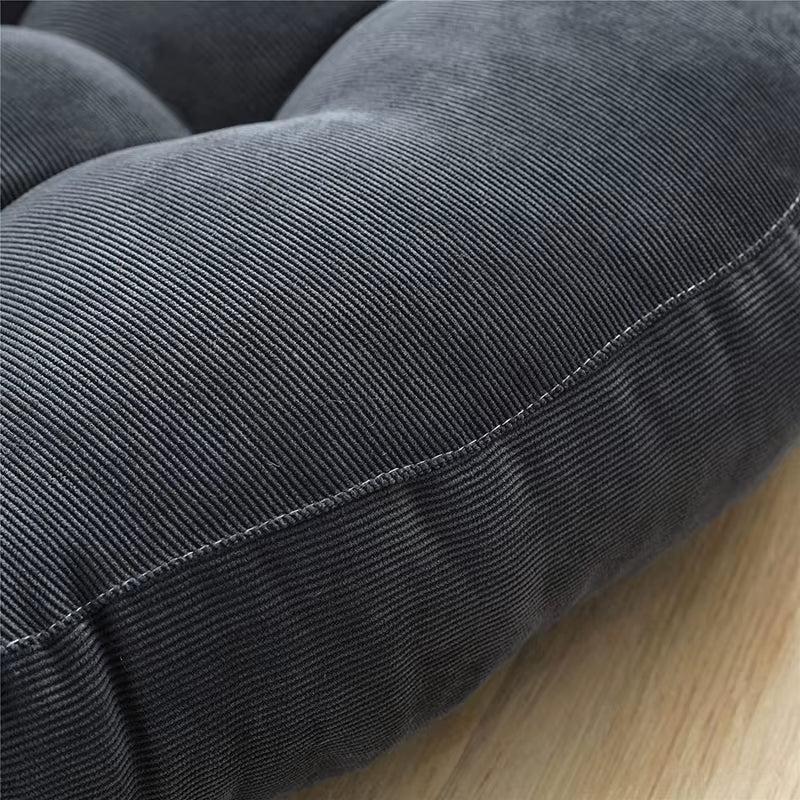 Close view of the stitched edge seam of the dark grey corduroy cushion.