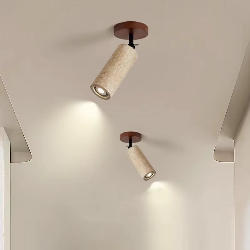 Two travertine ceiling spotlights aimed down from a ceiling