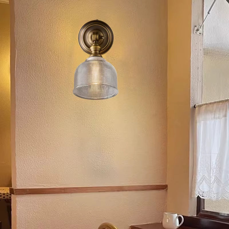 Brass wall sconce with ribbed glass shade and short arm