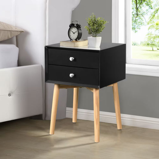 Black mid-century two-drawer nightstand beside a bed