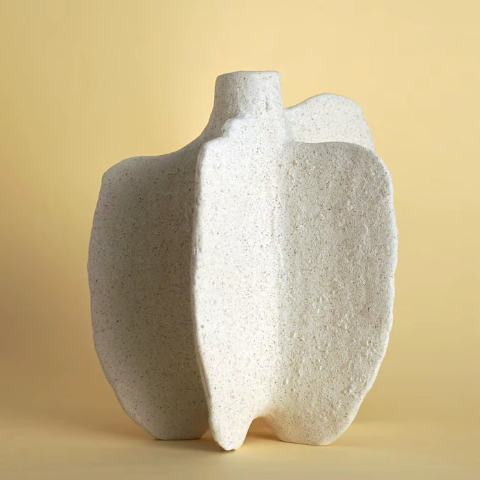 Matte white sculptural ceramic vase with a cleft block form, shown alone.