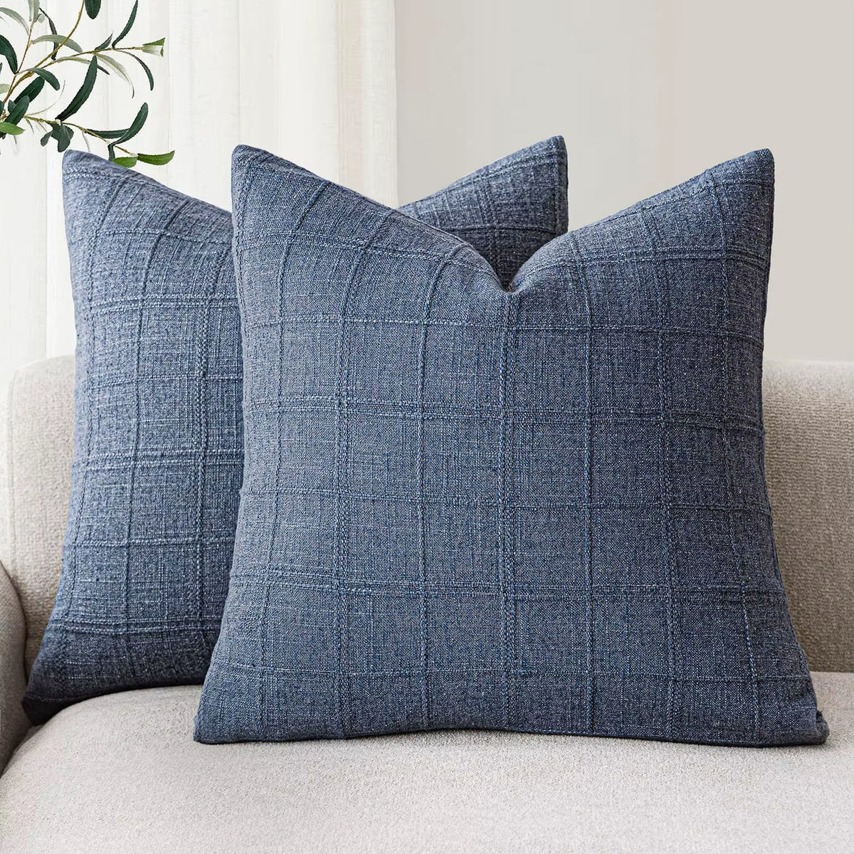 Navy chenille throw pillow covers on a sofa
