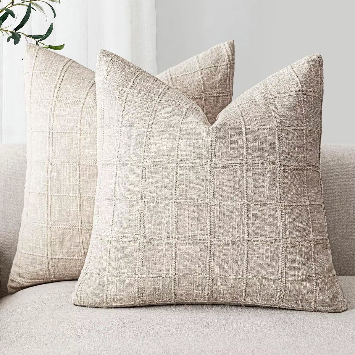Beige chenille throw pillow covers on a sofa