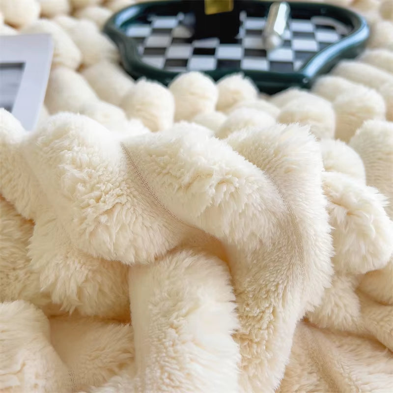 Close view of the soft ribbed pile of the ivory faux fur throw.