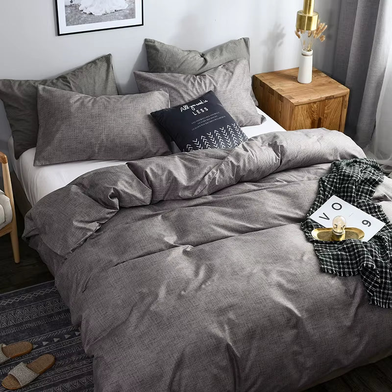 Grey duvet cover and pillowcases seen from the foot of the bed.