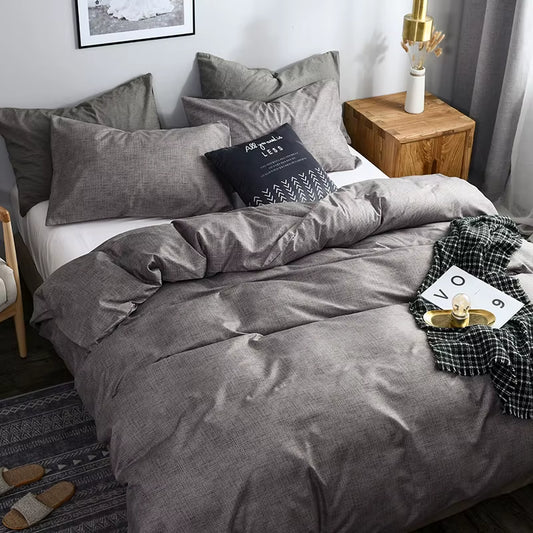 Grey duvet cover and pillowcases seen from the foot of the bed.