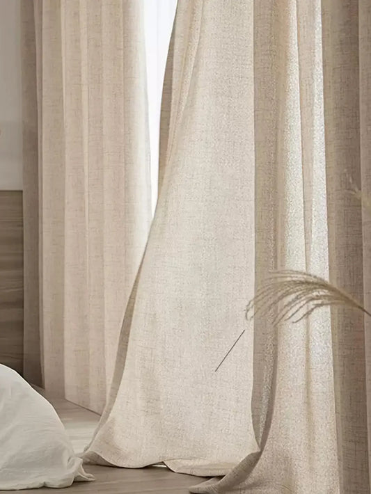 Natural beige cotton-linen curtain panels letting soft daylight into a bedroom.