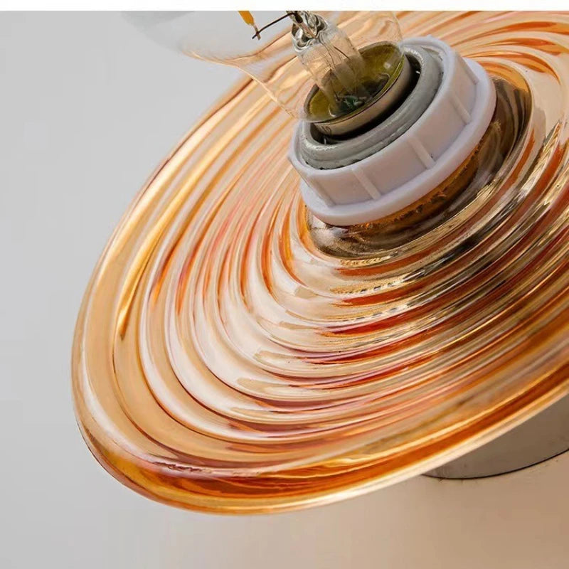 Close view of the amber ripple glass disc and its bulb socket.